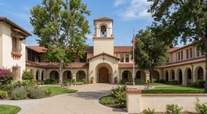 Mission-revival high school building with bell tower and arched entry, representing Fullerton high schools