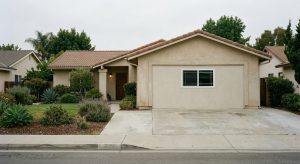 Close-up of a stucco wall seam where a home addition meets the original elevation